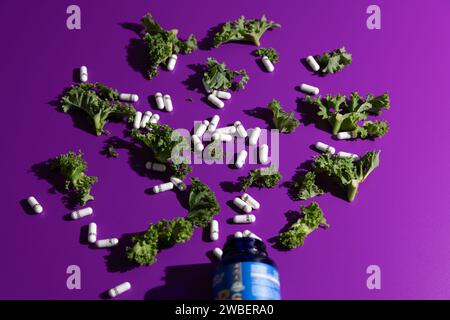 Minimal photo of Kale over plain purple vibrant vinyl backdrop in studio set up with harsh shadows Stock Photo