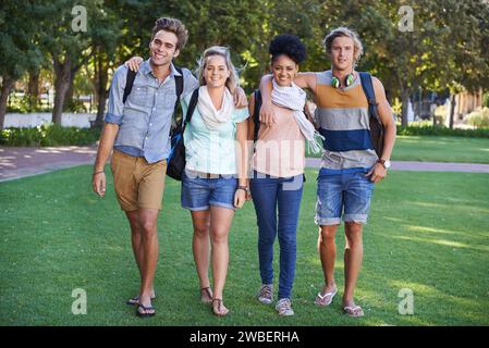 College, students and portrait in the park with friends on campus to study together with happiness. University, academy and people with diversity or Stock Photo