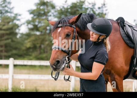 Female rider hand gently caressing beautiful thick red horse mane, close up shot. Equitation and animal lover concept. Stock Photo