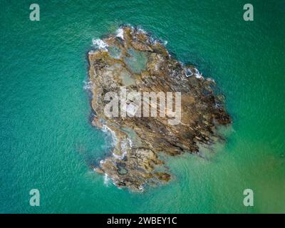 Top down aerial view of a small lighthouse on an offshore rock Stock Photo
