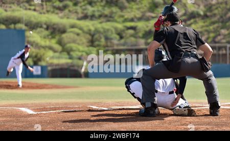 Baseball players in action on the stadium, baseball batter waiting to strike the ball. Baseball pitcher following through to pitch to right handed bat Stock Photo