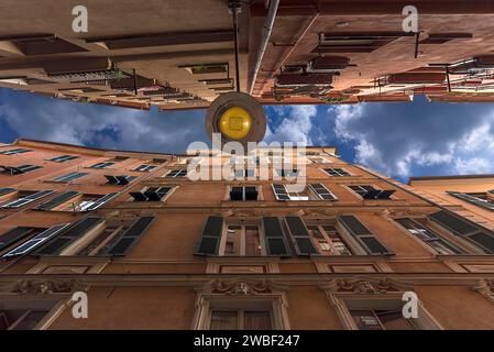 Tall apartment blocks in a small alley in the historic centre, Genoa, Italy Stock Photo