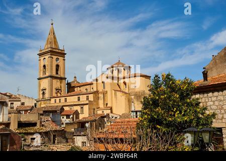 View over the roofs of an old town with church and trees under a blue sky, Novara di Sicilia, Sicily, Italy Stock Photo
