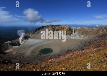 A majestic aerial view of a crater filled with crystal clear water Stock Photo