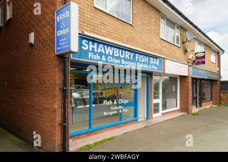 Shawbury, UK - May 5, 2023; Row of small english businesses including traditional fish and chip shop Stock Photo