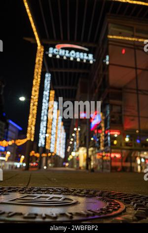 Shallow depth of field shows city lights and neon signs at night, Schloessle Galerie, Pforzheim, Germany Stock Photo