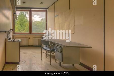 An abandoned laboratory with empty chairs and a blackboard in a dilapidated building, Biotech, abandoned university, Lost Place, Sint-Genesius-Rode Stock Photo