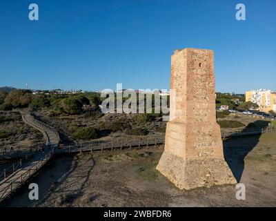 beautiful sunrise on the beach of Cabopino next to tower robbers, Marbella Stock Photo