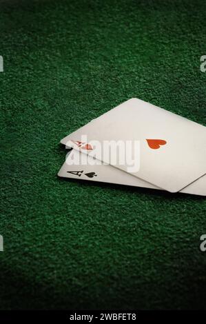 In this captivating image, a trio of playing cards and a vibrant playing chip are scattered on the floor of a stylish and bustling gambling room Stock Photo