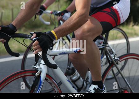 Intense road bike race: cyclists speeding through scenic route, showcasing determination and athleticism. Stock Photo