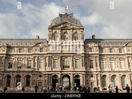 France, Paris - Jan 03, 2024 - Exterior of Palais du Louvre (Pavillon de l'Horloge) or The Louvre Palace. West facade of the sully wing, is a magnific Stock Photo