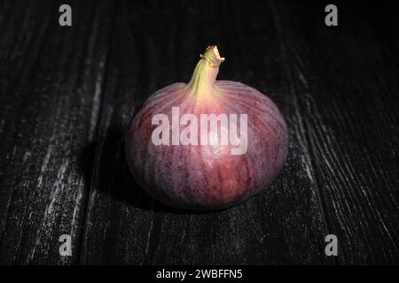 figs on black wood background Stock Photo