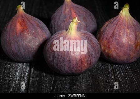 figs on black wood background Stock Photo
