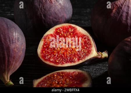 sliced figs on wood background Stock Photo