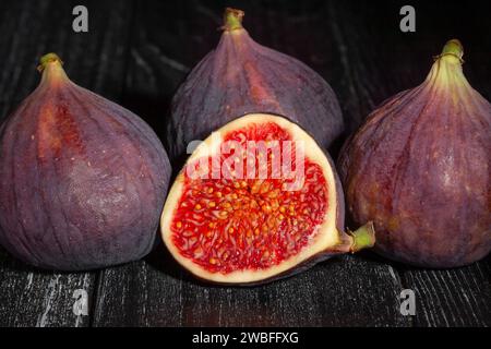sliced figs on wood background Stock Photo