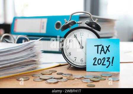 Tax income refund concept with memo and clock in office Stock Photo