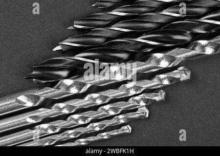 Set of different drill bits on dark background Stock Photo