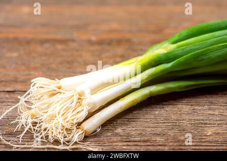 Natural and fresh green onions on wooden board Stock Photo
