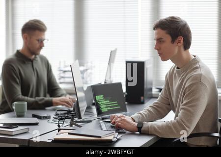 Focused Programmer Developing Cybersecurity Software Stock Photo
