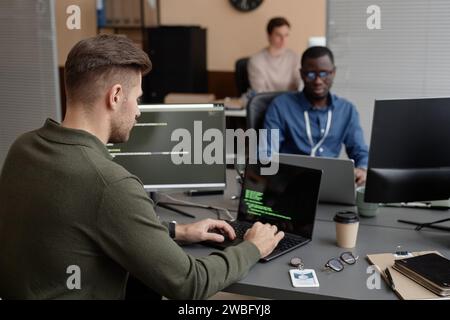 Cybersecurity Developer Working on Laptop Stock Photo
