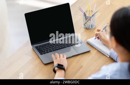 High angle view woman using laptop with blank screen Stock Photo