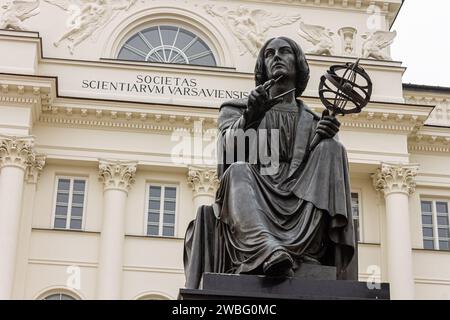 Warsaw, Poland. Monument to Nicolaus Copernicus, a Renaissance mathematician and astronomer in front of the Polish Academy of Sciences Staszic Palace Stock Photo