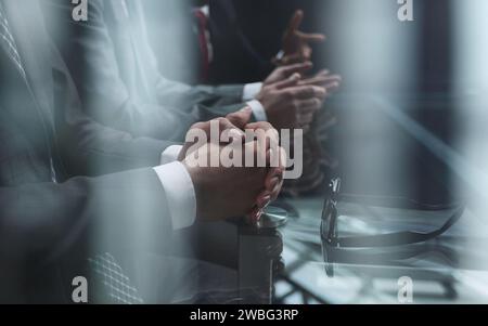Business partners discuss financial reports, plan an investment strategy. Team of three Stock Photo