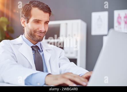 doctor waving hand to patient via laptop video link Stock Photo