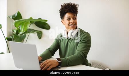 Happy black guy independent contractor working from cafe Stock Photo