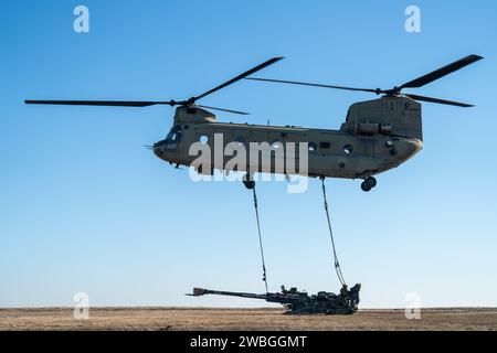 Artillery Soldiers from Charlie Battery, 3rd Battalion, 320th Field Artillery Regiment, 3rd Brigade Combat Team, 101st Airborne Division 'Task Force 82,' conduct sling-load training and elevator drills on Mihail Kogalniceanu Air Base, Romania, Jan. 5, 2024. CH-47 Chinooks from the 3rd Attack Helicopter Battalion, 1st Aviation Regiment, 1st Combat Aviation Brigade, 1st Infantry Division, supported the 101st Airborne Division by moving M777 howitzers by air to increase readiness and proficiency in air assault operations. (U.S. Army photo by Sgt. 1st Class Jonathan Hornby) Stock Photo