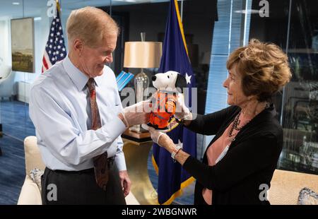NASA Administrator Bill Nelson, left, is seen with Jeannie Schulz, widow of Peanuts gang creator Charles M. Schulz, right, holding the Artemis I Snoopy zero gravity indicator, Wednesday, April 5, 2023, during a visit to the Mary W. Jackson NASA Headquarters building in Washington. Schulz awarded a NASA Exceptional Achievement Medal by Administrator Nelson at an “Our Blue Planet” concert at the John F. Kennedy Center for the Performing Arts. Snoopy rode along as the zero gravity indicator on NASA’s Artemis I mission as part of a partnership with the agency and continues to help NASA inspire kid Stock Photo