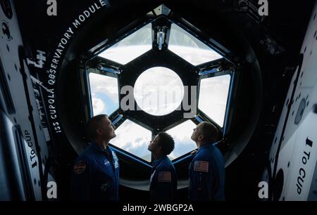 NASA astronauts Kjell Lindgren, left, Jessica Watkins, center, and Robert Hines, right, are seen in the in the One World Connected gallery looking at an interactive recreation of the International Space Station’s Cupola, Tuesday, March 28, 2023 at the Smithsonian’s National Air and Space Museum in Washington. Lindgren, Watkins, and Hines spent 170 days in space as part of Expeditions 67 and 68 aboard the International Space Station. Photo Credit: (NASA/Joel Kowsky) Stock Photo