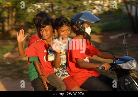 Young children riding a motorcycle, Beng Mealea, Cambodia. Stock Photo