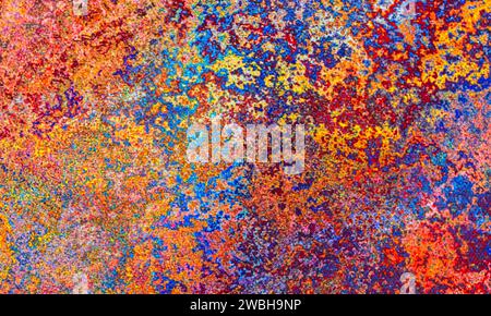 Abstract colorful background with chaotic spots of paint over canvas backdrop Stock Photo