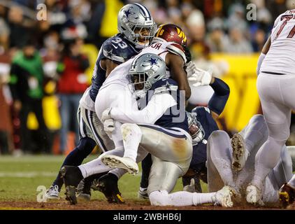 Dallas Cowboys safety Donovan Wilson (6) makes the quick tackle of Washington Commanders running back Brian Robinson Jr. (8) at FedEx Field in Landover MD on January 7 2023 (Alyssa Howell for Image of Sport) Stock Photo