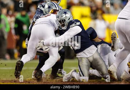 Dallas Cowboys safety Donovan Wilson (6) makes the quick tackle of Washington Commanders running back Brian Robinson Jr. (8) at FedEx Field in Landover MD on January 7 2023 (Alyssa Howell for Image of Sport) Stock Photo