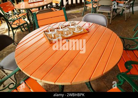 A set of six glass cups on table Stock Photo