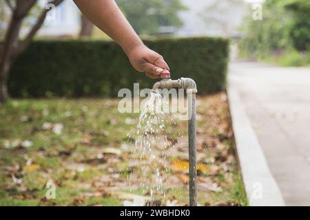 Old faucet outside the house dripping Stock Photo