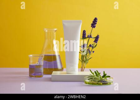 Front view of white cosmetic bottle without labeled placed on podium with fresh lavender flower on yellow background. Mockup for design, organic cosme Stock Photo