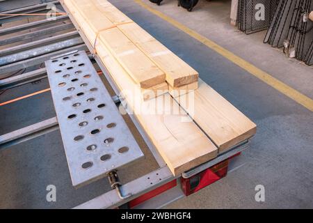 Wooden planks securely fastened to a construction trailer at a building supply store, preparations for either repairs or construction work. Stock Photo