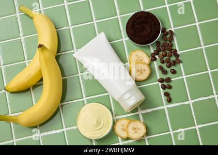 Glass petri dishes of coffee powder and cream texture. Unlabeled white tube. Banana (Musaceae) contains nutrients that are beneficial for your hair Stock Photo