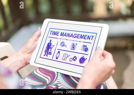 Time management concept shown on a tablet held by a woman Stock Photo
