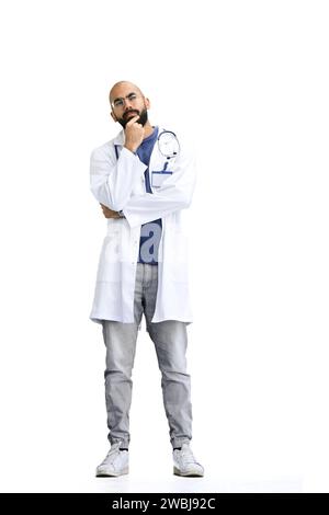 A male doctor, on a white background, in full height, thinks Stock Photo