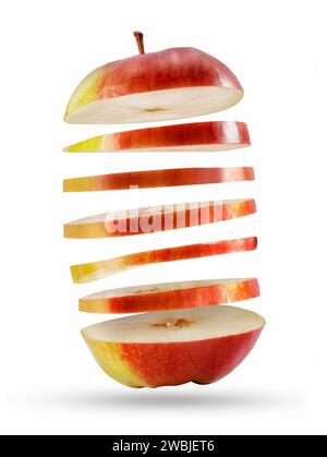 Fresh red golden apple cut into slices flying in the air isolated on white background. Stock Photo