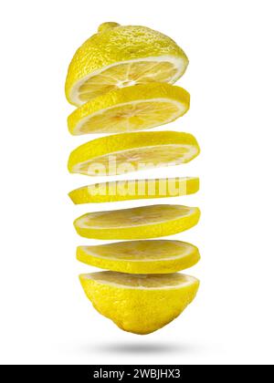 Sliced pieces of yellow fresh lemon flying in the air isolated on white. Stock Photo