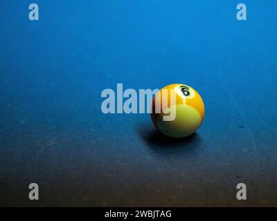 Closeup of colorful billiard balls on blue pool table in daylight Stock Photo