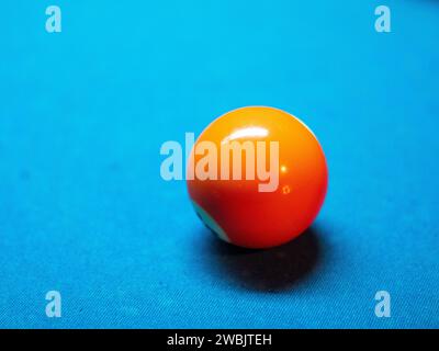 Closeup of colorful billiard balls on blue pool table in daylight Stock Photo