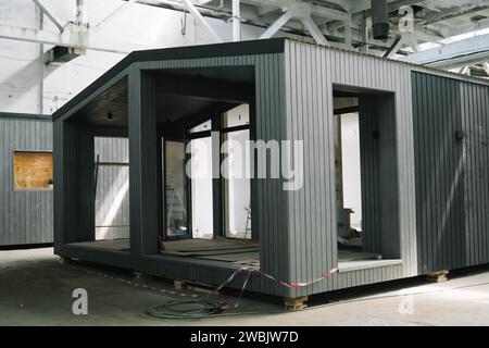 A new wooden modular prefabricated house inside in manufacturing facility. Stock Photo