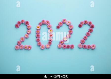 2022 made from fresh flowers on blue background. Top view. Stock Photo