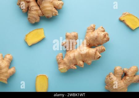 Fresh ginger root on blue background. Vitamins. Top view. Stock Photo
